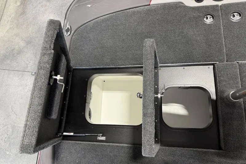 Slide: The Image of Open storage compartments on a 2025 Skeeter ZXR20 boat deck. - 18
