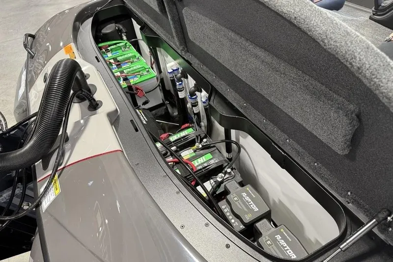 Slide: The Image of 2025 Skeeter ZXR20 boat battery compartment with multiple batteries and wiring. - 19