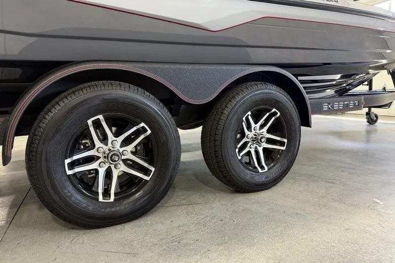 Slide: The Image of 2025 Skeeter ZXR20 boat trailer with dual black alloy wheels. - 3