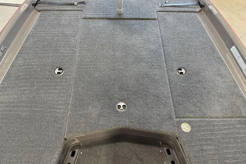 Slide: The Image of 2025 Skeeter ZXR20 boat deck with gray carpet and storage compartments. - 7