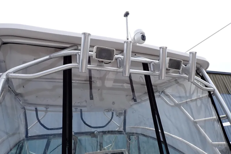 Slide: The Image of 2002 Pro-Line 33 WA boat with rod holders and mounted camera on the roof. - 100