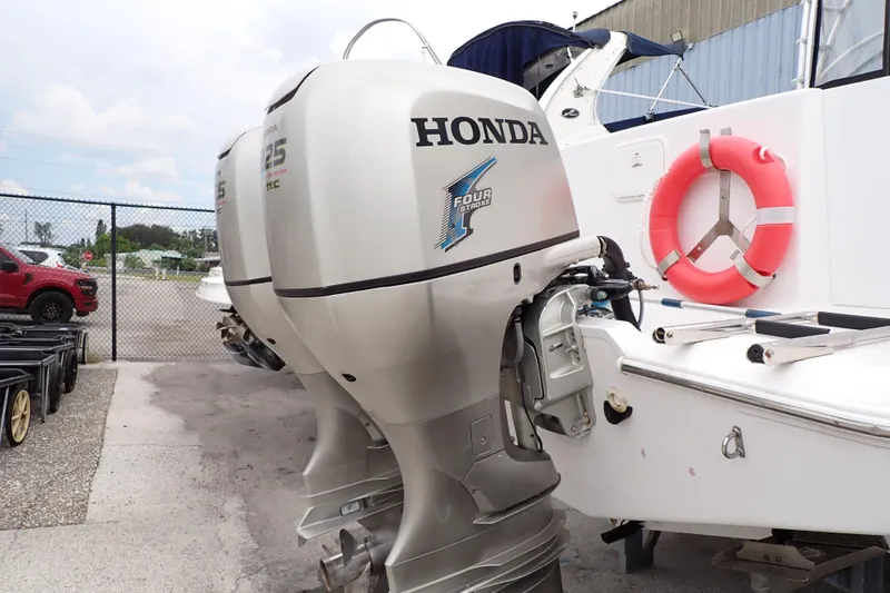 Slide: The Image of 2002 Pro-Line 33 WA boat with Honda outboard motors and a red life preserver. - 101