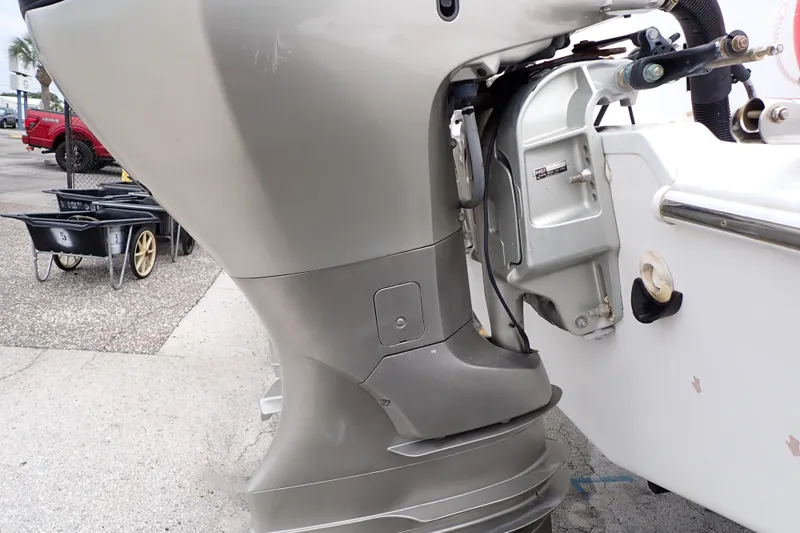 Slide: The Image of 2002 Pro-Line 33 WA boat motor close-up, showcasing engine details and dockside setting. - 102