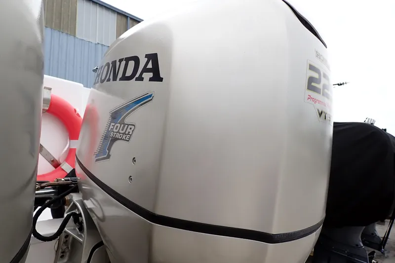 Slide: The Image of 2002 Pro-Line 33 WA boat with Honda 225 four-stroke outboard engine. - 104