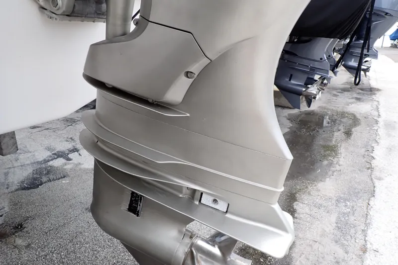 Slide: The Image of Outboard motor of a 2002 Pro-Line 33 WA boat on a concrete surface. - 106