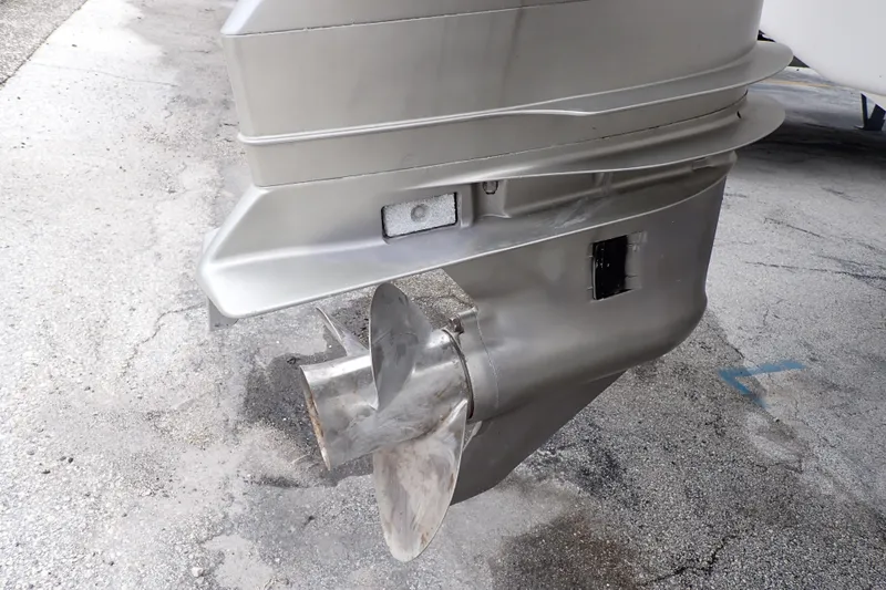 Slide: The Image of 2002 Pro-Line 33 WA boat propeller and lower unit on concrete surface. - 111