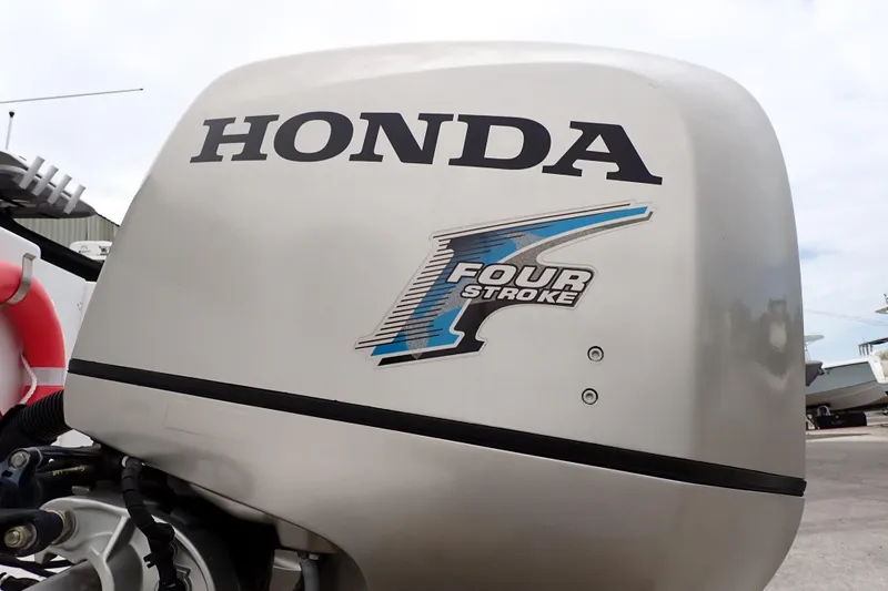 Slide: The Image of Honda four-stroke outboard motor on 2002 Pro-Line 33 WA boat. - 112