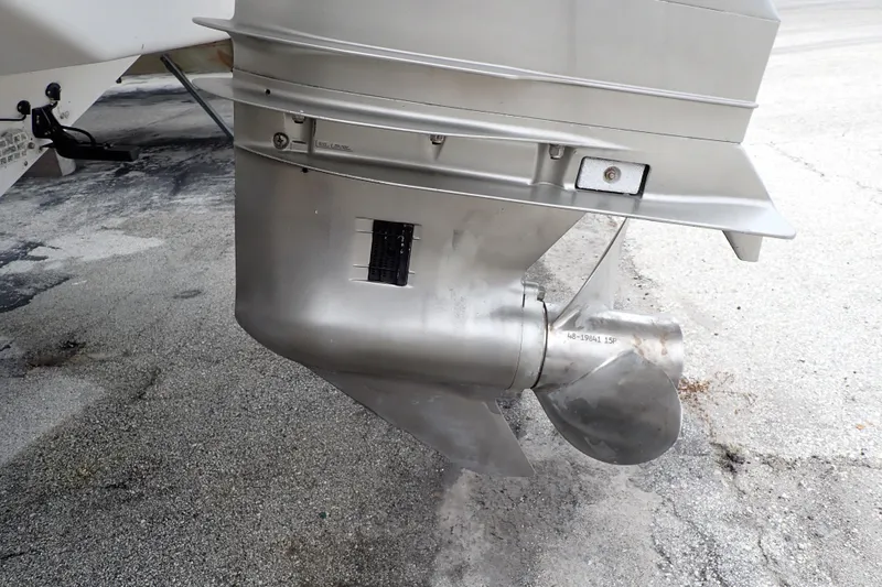Slide: The Image of 2002 Pro-Line 33 WA boat propeller and lower unit on pavement. - 115