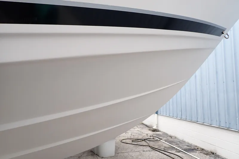 Slide: The Image of 2002 Pro-Line 33 WA boat hull close-up, showcasing sleek design and smooth finish. - 126