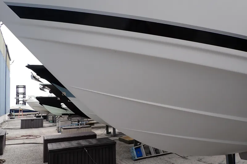 Slide: The Image of 2002 Pro-Line 33 WA boat hulls in storage, side view. - 128