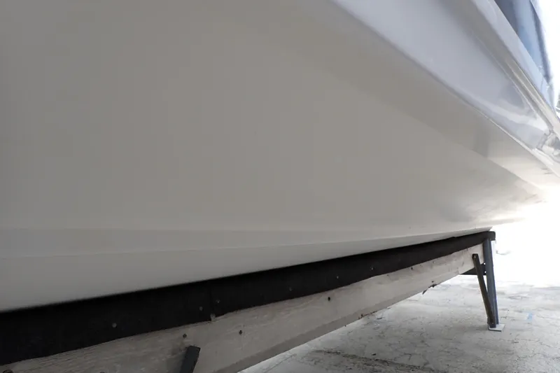 Slide: The Image of 2002 Pro-Line 33 WA boat hull on a support stand, side view. - 130