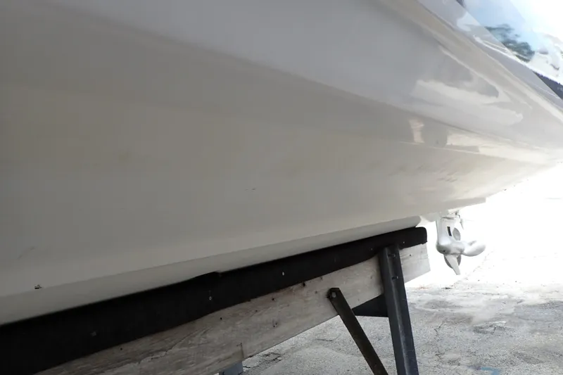 Slide: The Image of 2002 Pro-Line 33 WA boat hull on a stand, showcasing sleek design. - 131
