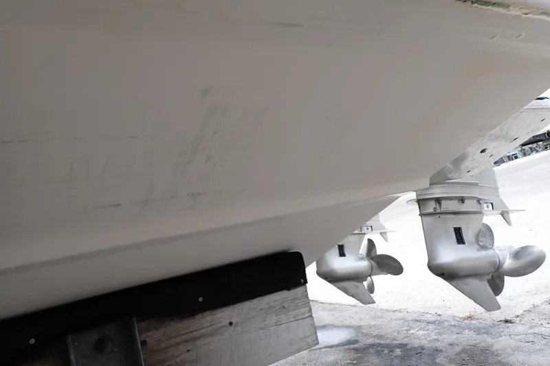 Slide: The Image of 2002 Pro-Line 33 WA boat hull and propellers on trailer. - 132