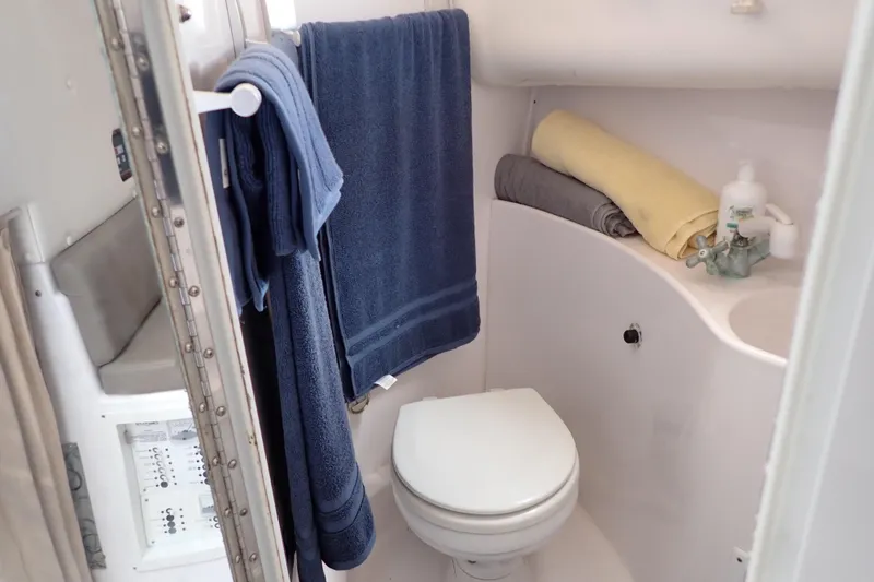 Slide: The Image of Compact bathroom in 2002 Pro-Line 33 WA boat with towels and toiletries. - 25