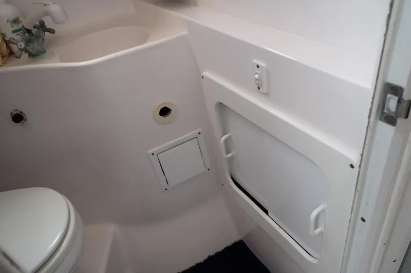 Slide: The Image of 2002 Pro-Line 33 WA boat bathroom interior with sink and storage compartment. - 27