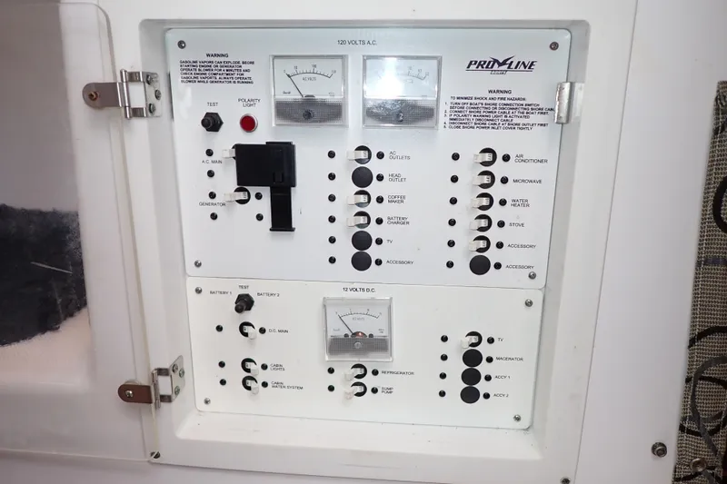 Slide: The Image of Control panel of a 2002 Pro-Line 33 WA boat, featuring various switches and gauges. - 30