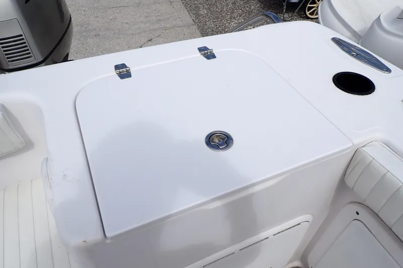 Slide: The Image of 2002 Pro-Line 33 WA boat deck with storage compartment and cup holder. - 34