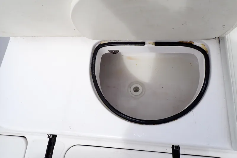 Slide: The Image of Livewell compartment on a 2002 Pro-Line 33 WA boat, featuring a white interior. - 37