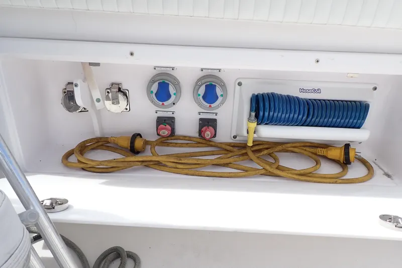 Slide: The Image of 2002 Pro-Line 33 WA boat utility panel with hoses and controls. - 39