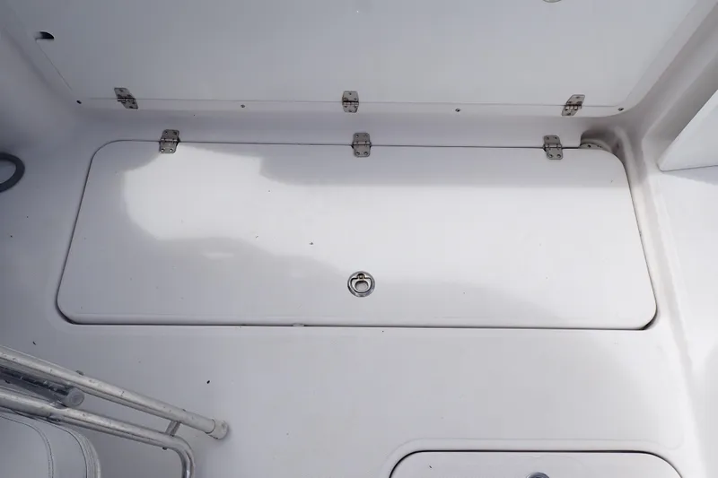 Slide: The Image of 2002 Pro-Line 33 WA boat storage compartment with metal hinges and latch. - 42