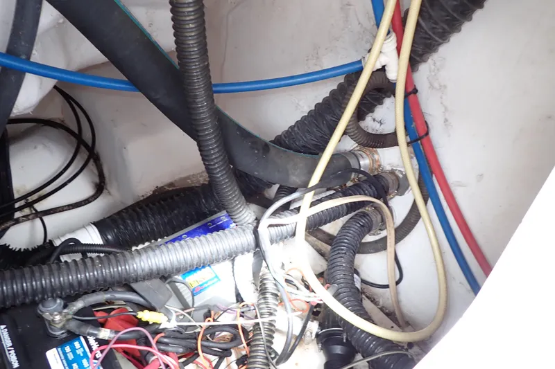 Slide: The Image of Wiring and hoses inside a 2002 Pro-Line 33 WA boat, showcasing electrical and plumbing systems. - 47