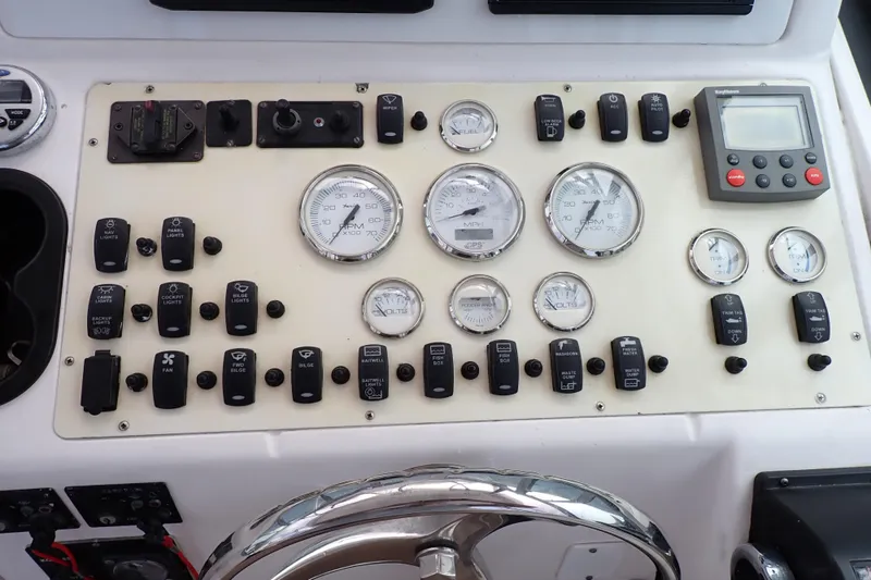 Slide: The Image of Control panel of a 2002 Pro-Line 33 WA boat with gauges and switches. - 51