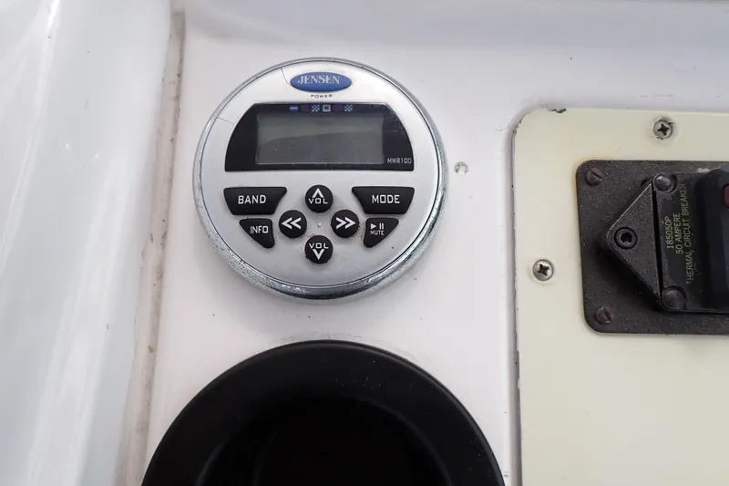 Slide: The Image of Jensen MWR100 marine stereo control on 2002 Pro-Line 33 WA boat dashboard. - 52