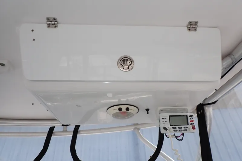 Slide: The Image of 2002 Pro-Line 33 WA boat console with radio and storage compartment. - 55