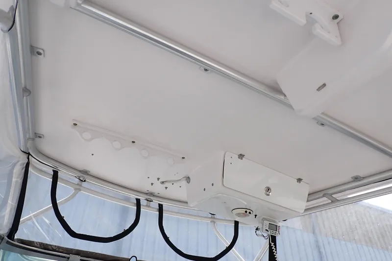 Slide: The Image of 2002 Pro-Line 33 WA boat interior ceiling with mounted equipment and storage. - 65