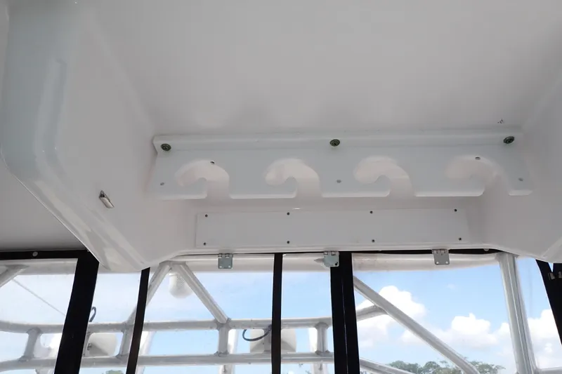 Slide: The Image of 2002 Pro-Line 33 WA boat interior with rod holders and windows. - 66