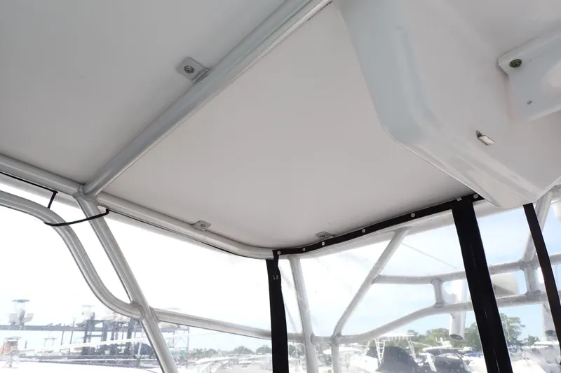 Slide: The Image of 2002 Pro-Line 33 WA boat interior with white ceiling and clear windows. - 67