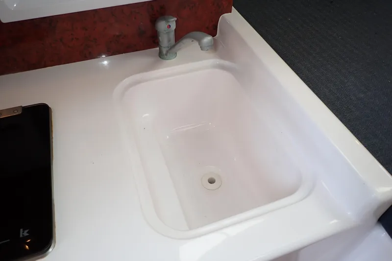 Slide: The Image of White sink with faucet in 2002 Pro-Line 33 WA boat interior. - 71