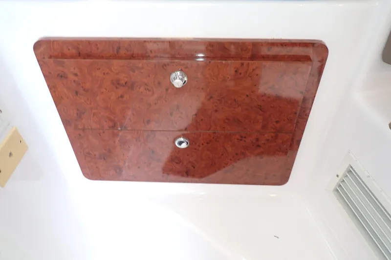 Slide: The Image of 2002 Pro-Line 33 WA boat interior with wood panel and chrome handles. - 76