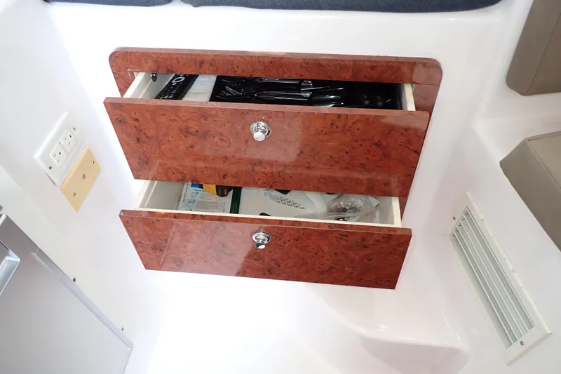 Slide: The Image of Wooden drawers in 2002 Pro-Line 33 WA boat interior, showcasing storage space. - 77