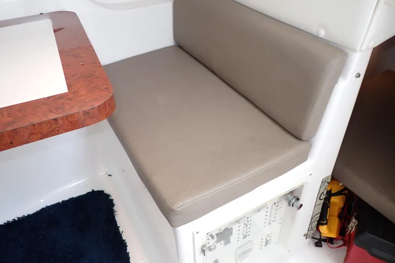 Slide: The Image of 2002 Pro-Line 33 WA cabin interior with cushioned seating and wooden table. - 78