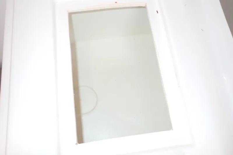 Slide: The Image of White rectangular compartment on a 2002 Pro-Line 33 WA boat. - 79