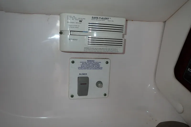 Slide: The Image of 2002 Pro-Line 33 WA boat interior with carbon monoxide alarm and blower switch. - 83
