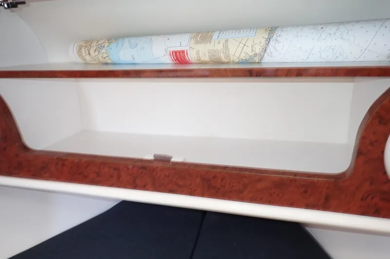 Slide: The Image of 2002 Pro-Line 33 WA cabin storage with rolled nautical chart. - 85