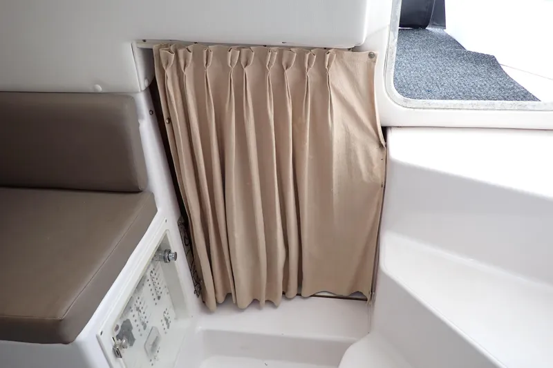 Slide: The Image of 2002 Pro-Line 33 WA interior with beige curtain and cushioned seating. - 92