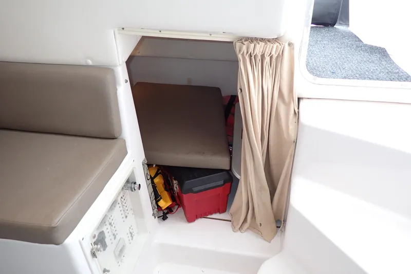 Slide: The Image of 2002 Pro-Line 33 WA cabin interior with seating and storage area. - 93