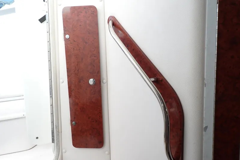 Slide: The Image of Interior of 2002 Pro-Line 33 WA boat with wood panel and metal handrail. - 94