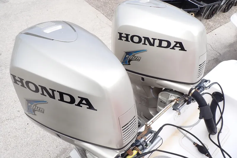 Slide: The Image of Twin Honda four-stroke outboard engines on a 2002 Pro-Line 33 WA boat. - 96