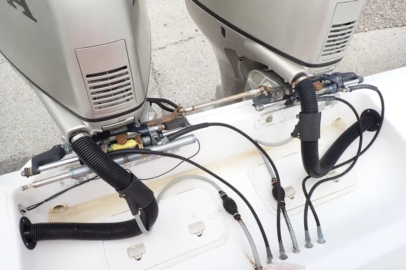 Slide: The Image of 2002 Pro-Line 33 WA boat with dual outboard motors and visible wiring connections. - 97