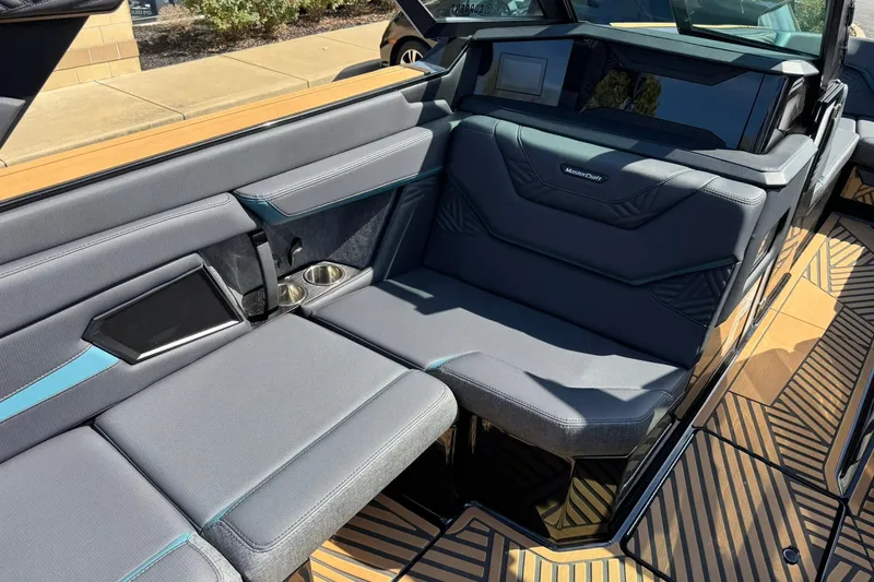 Slide: The Image of 2025 MasterCraft XStar 25 boat interior with sleek gray seating and modern design. - 10