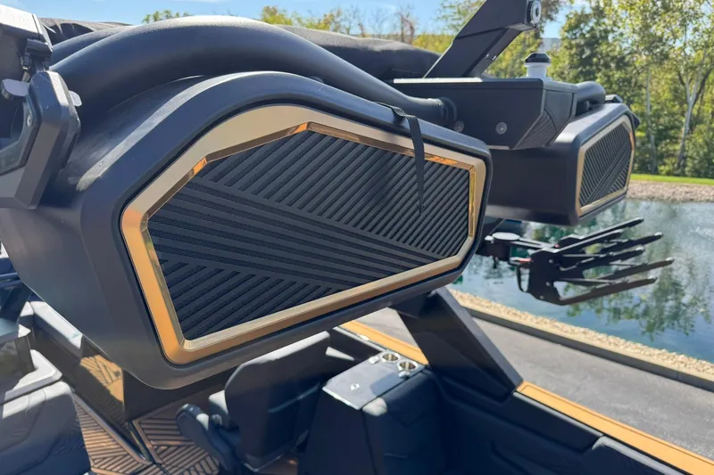 Slide: The Image of 2025 MasterCraft XStar 25 boat speakers with sleek design near a serene water backdrop. - 15