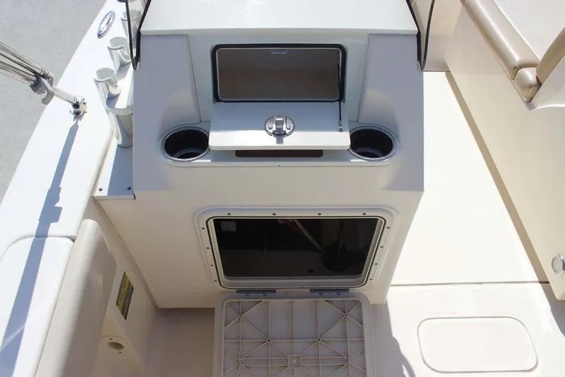 Slide: The Image of 2021 Scout 195 Sport Dorado boat interior with steering wheel and beige seating. - 12