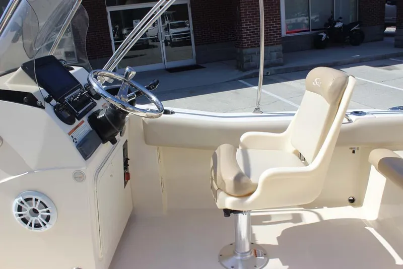 Slide: The Image of 2021 Scout 195 Sport Dorado boat interior with beige seating and cup holders. - 13