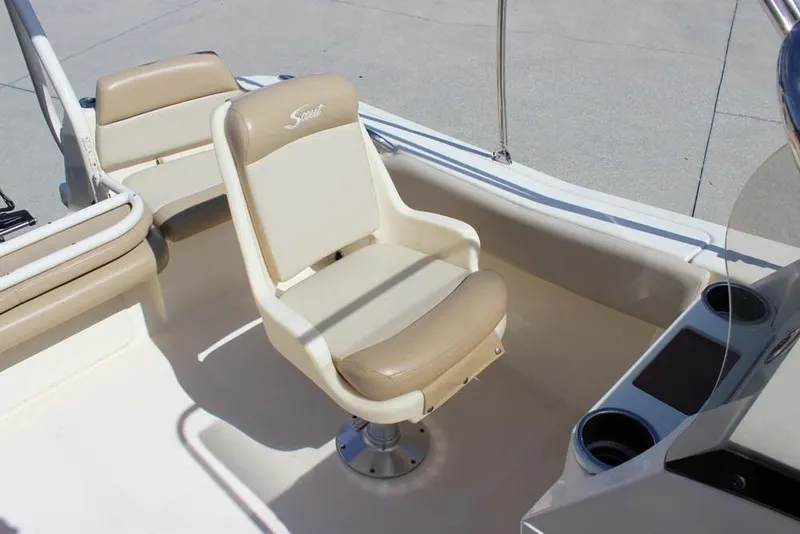Slide: The Image of 2021 Scout 195 Sport Dorado boat interior with beige seating and spacious layout. - 14