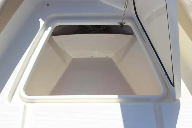 Slide: The Image of 2021 Scout 195 Sport Dorado boat interior with beige seating and outboard motor. - 18