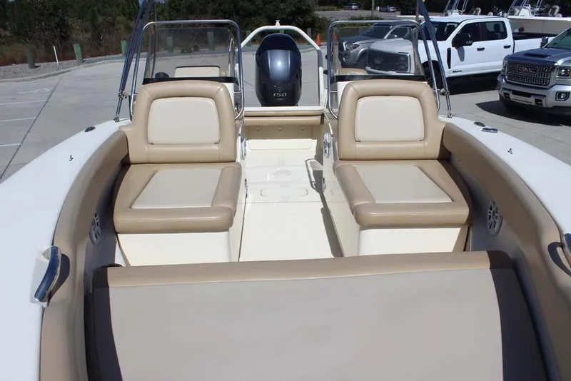 Slide: The Image of 2021 Scout 195 Sport Dorado boat interior with beige seating and storage compartments. - 19